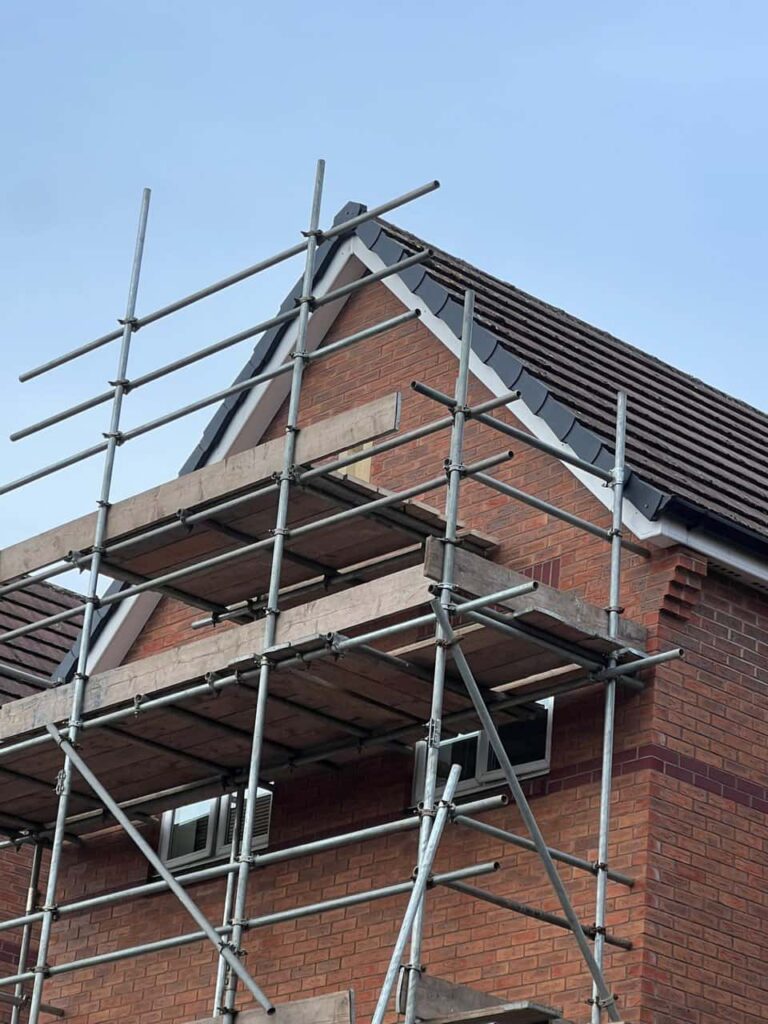 This is a photo of a roof which has just been repaired. There is a scaffold located at the gable end for access onto the roof. Works carried out by Waterlooville Roofing Repairs