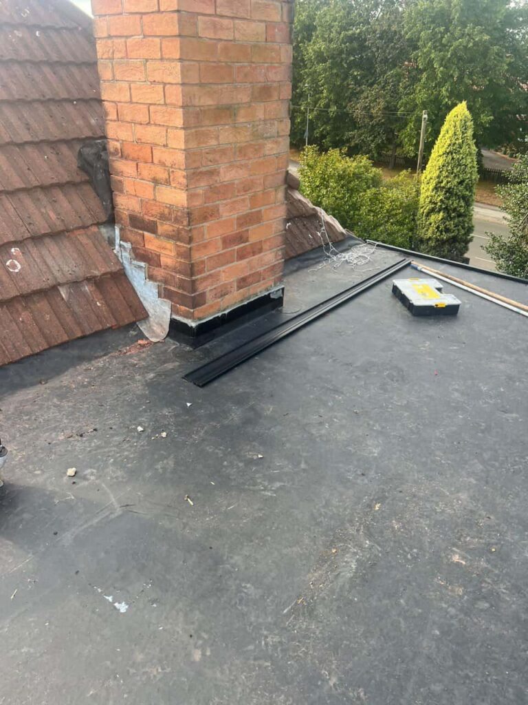 This is a photo of a flat roof which has just been repaired, there is also a chimney stack and some leadwork has also been dressed. Works carried out by Waterlooville Roofing Repairs